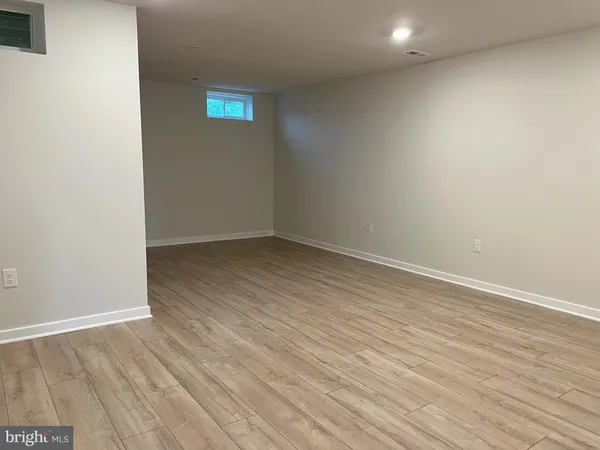 a view of room with wooden floor