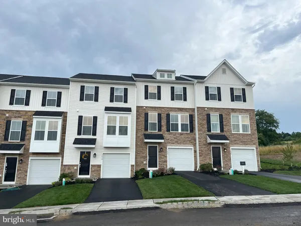 a front view of residential houses with yard