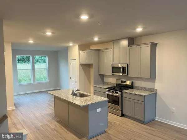 a kitchen with stainless steel appliances granite countertop a stove and a sink