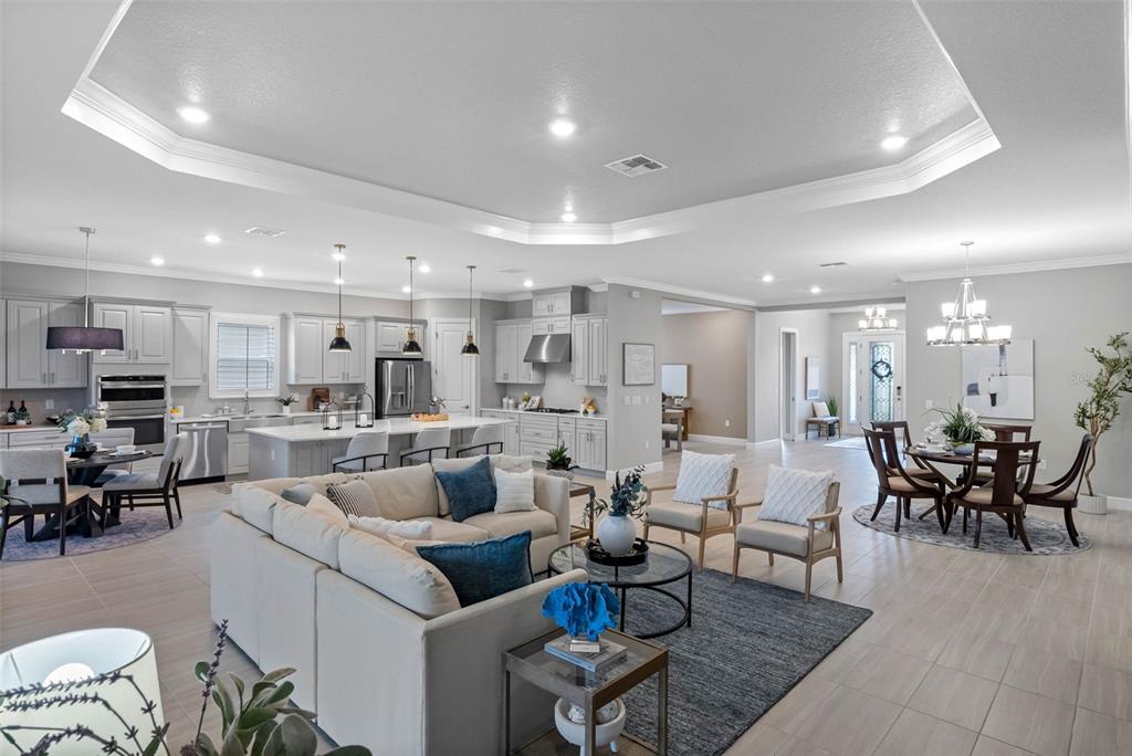 4795 Freccia Loop Wesley Chapel, FL 33543 - Photo 11 of 51 a living room with lots of furniture and view of kitchen