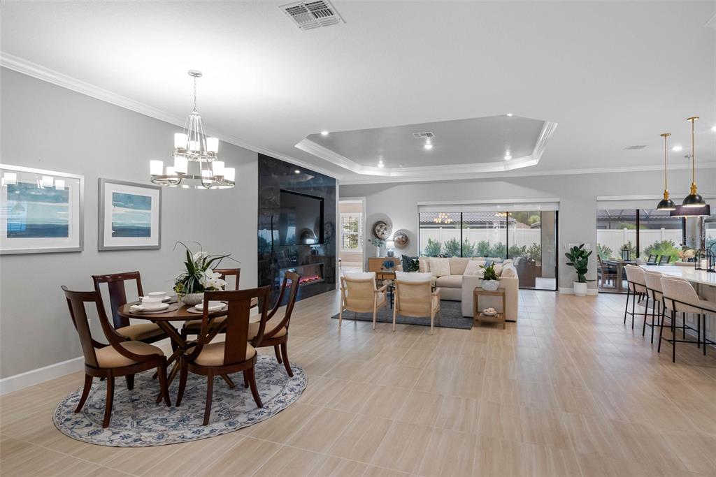 4795 Freccia Loop Wesley Chapel, FL 33543 - Photo 12 of 51 a view of a dining room with furniture window and wooden floor