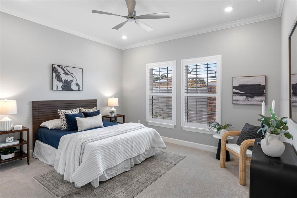 4795 Freccia Loop Wesley Chapel, FL 33543 - Photo 27 of 51 a bedroom with a large bed and a potted plant