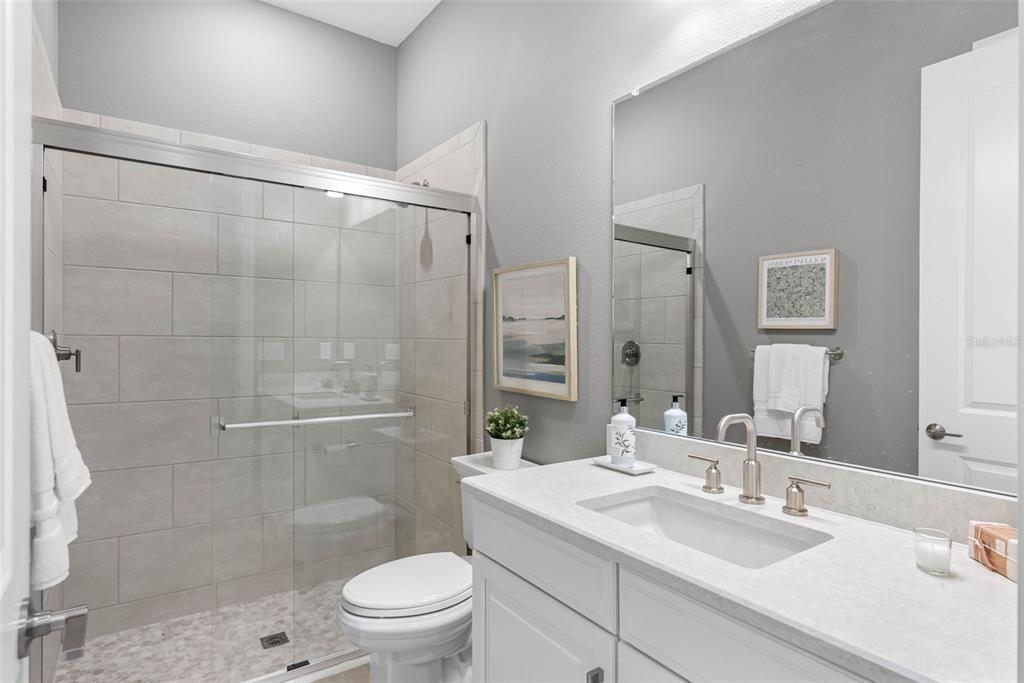 4795 Freccia Loop Wesley Chapel, FL 33543 - Photo 30 of 51 a bathroom with a sink toilet vanity and shower