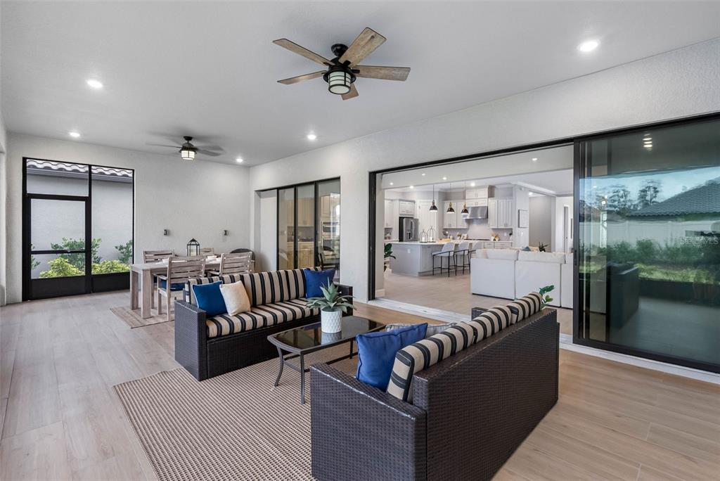 4795 Freccia Loop Wesley Chapel, FL 33543 - Photo 32 of 51 a living room with furniture kitchen view and a large window