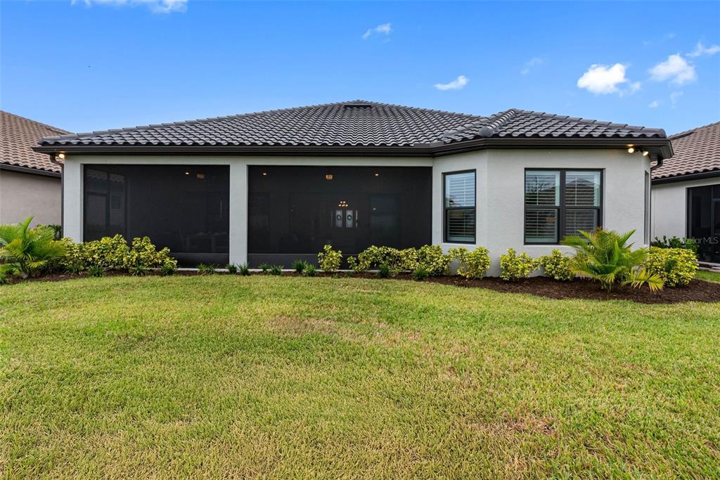 4795 Freccia Loop Wesley Chapel, FL 33543 - Photo 37 of 51 a front view of a house with a garden