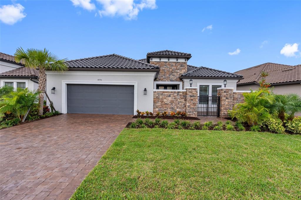 4795 Freccia Loop Wesley Chapel, FL 33543 - Photo 39 of 51 a front view of a house with a yard and garage