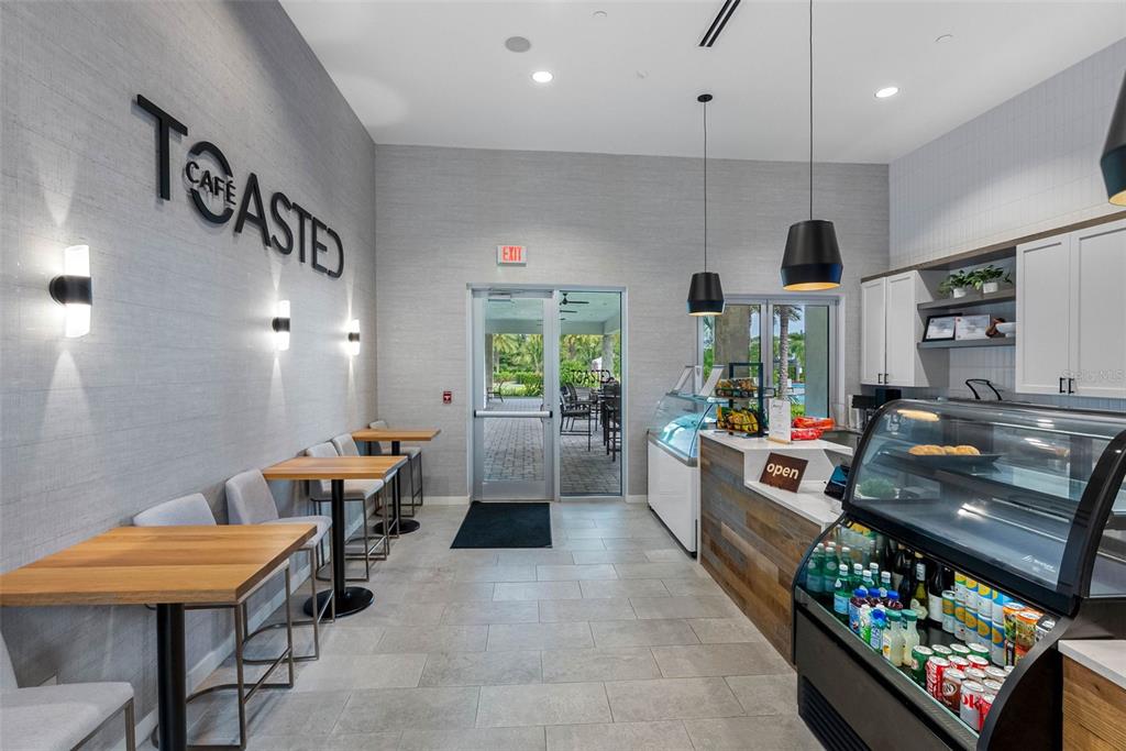 4795 Freccia Loop Wesley Chapel, FL 33543 - Photo 46 of 51 a view of a dining room with furniture window and wooden floor