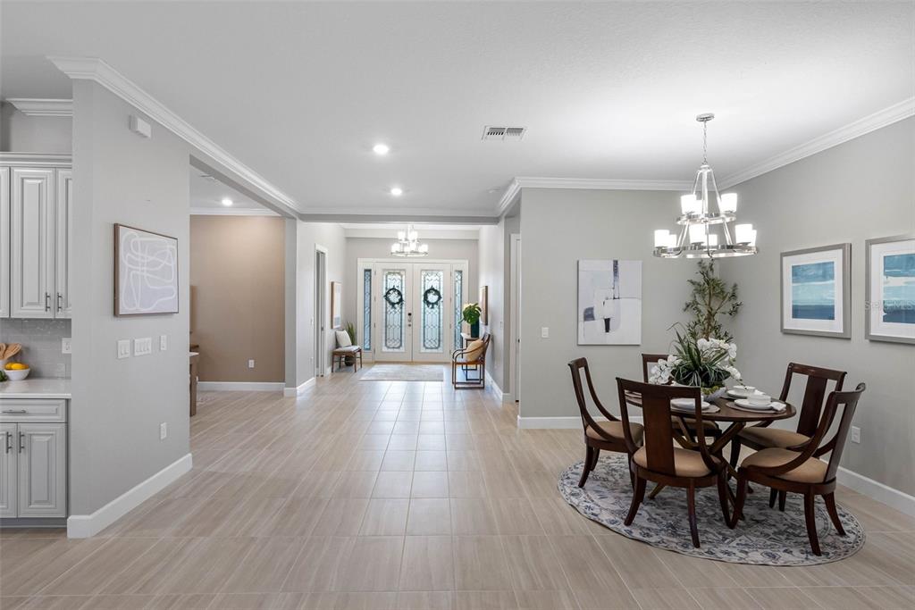 4795 Freccia Loop Wesley Chapel, FL 33543 - Photo 7 of 51 a view of a dining room with furniture and wooden floor
