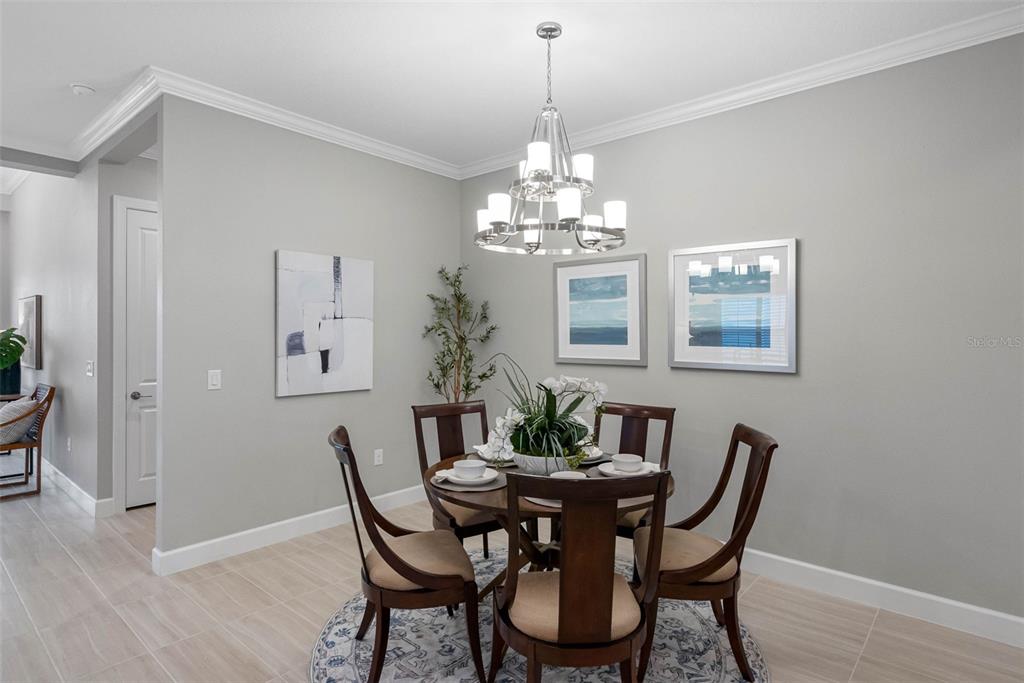 4795 Freccia Loop Wesley Chapel, FL 33543 - Photo 8 of 51 a view of a dining room with furniture and chandelier