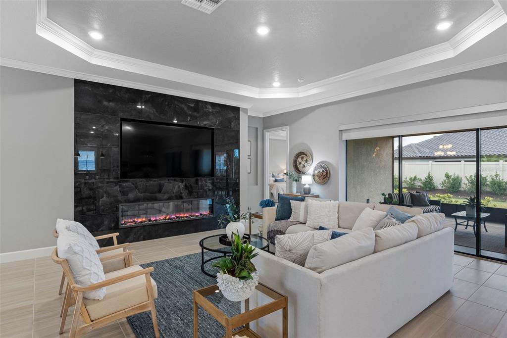 4795 Freccia Loop Wesley Chapel, FL 33543 - Photo 9 of 51 a living room with furniture and a flat screen tv