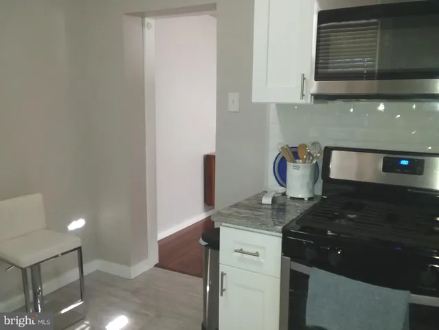 a living room with hard wood floors and a window
