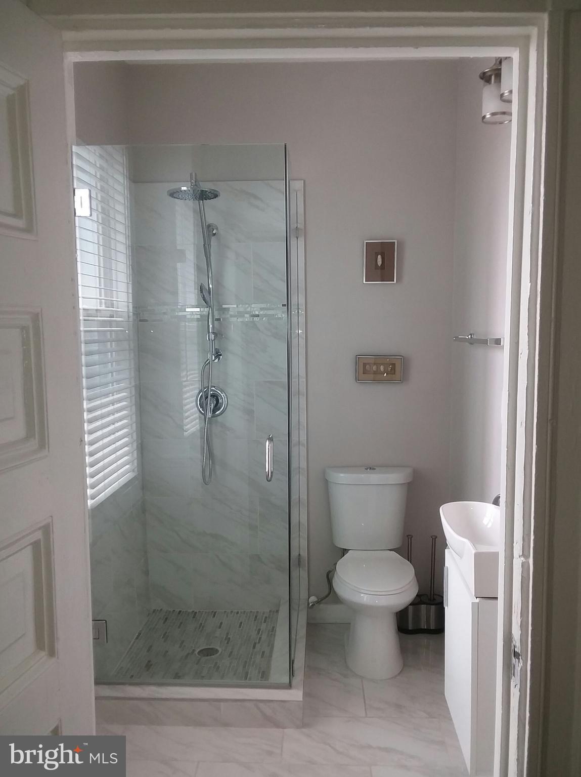 2012 Mt Royal Terrace, Unit 4 Baltimore, MD 21217 - Photo 8 of 55 a bathroom with a toilet and a shower