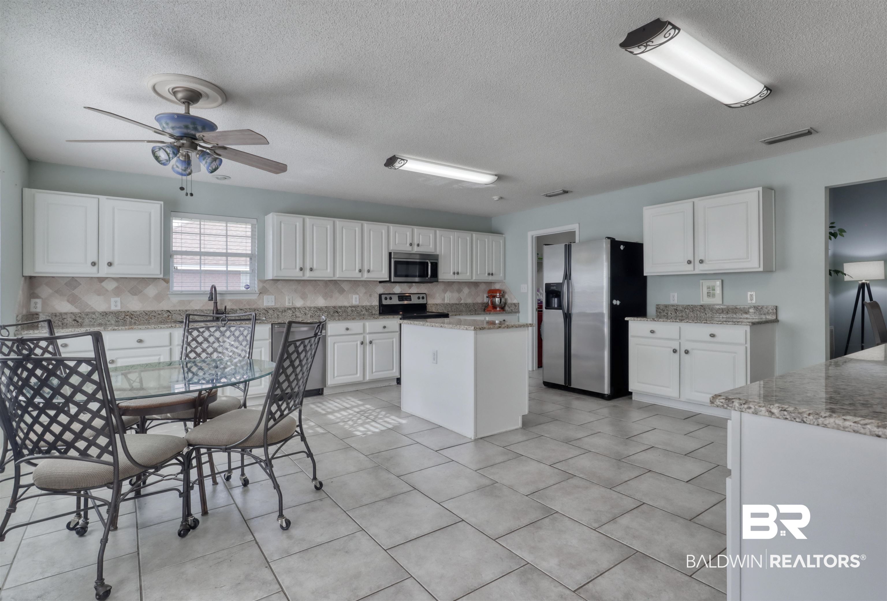 12893 Hunters Chase Foley, AL 36535 - Photo 20 of 42 Kitchen featuring white cabinets, visible vents, ceiling fan, stainless steel appliances, and backsplash