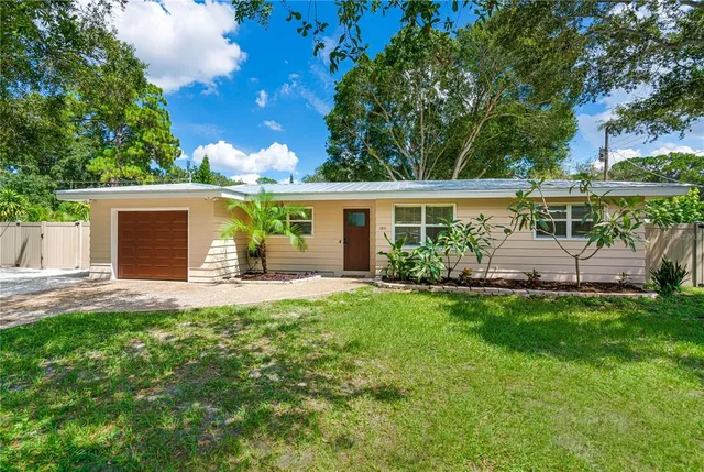 a view of a house with a yard and sitting area