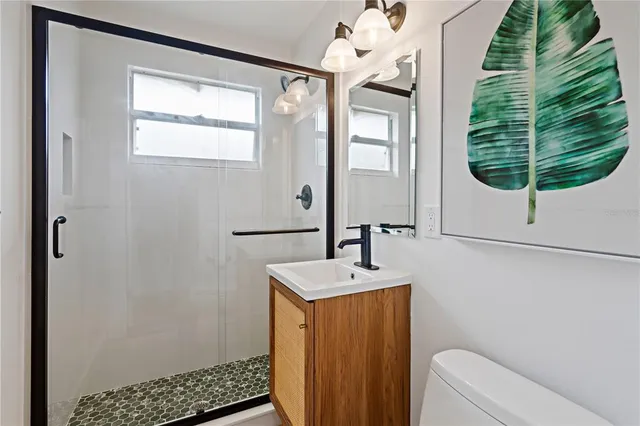 a bathroom with a sink a mirror and a window