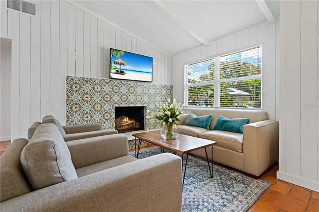 a living room with furniture window and a fireplace