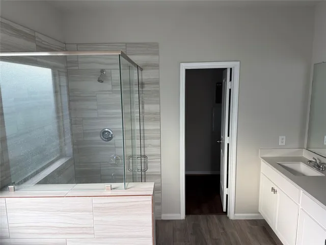 a bathroom with a shower and a sink