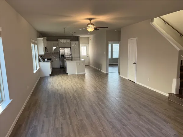 a view of a house and wooden floor in an empty room