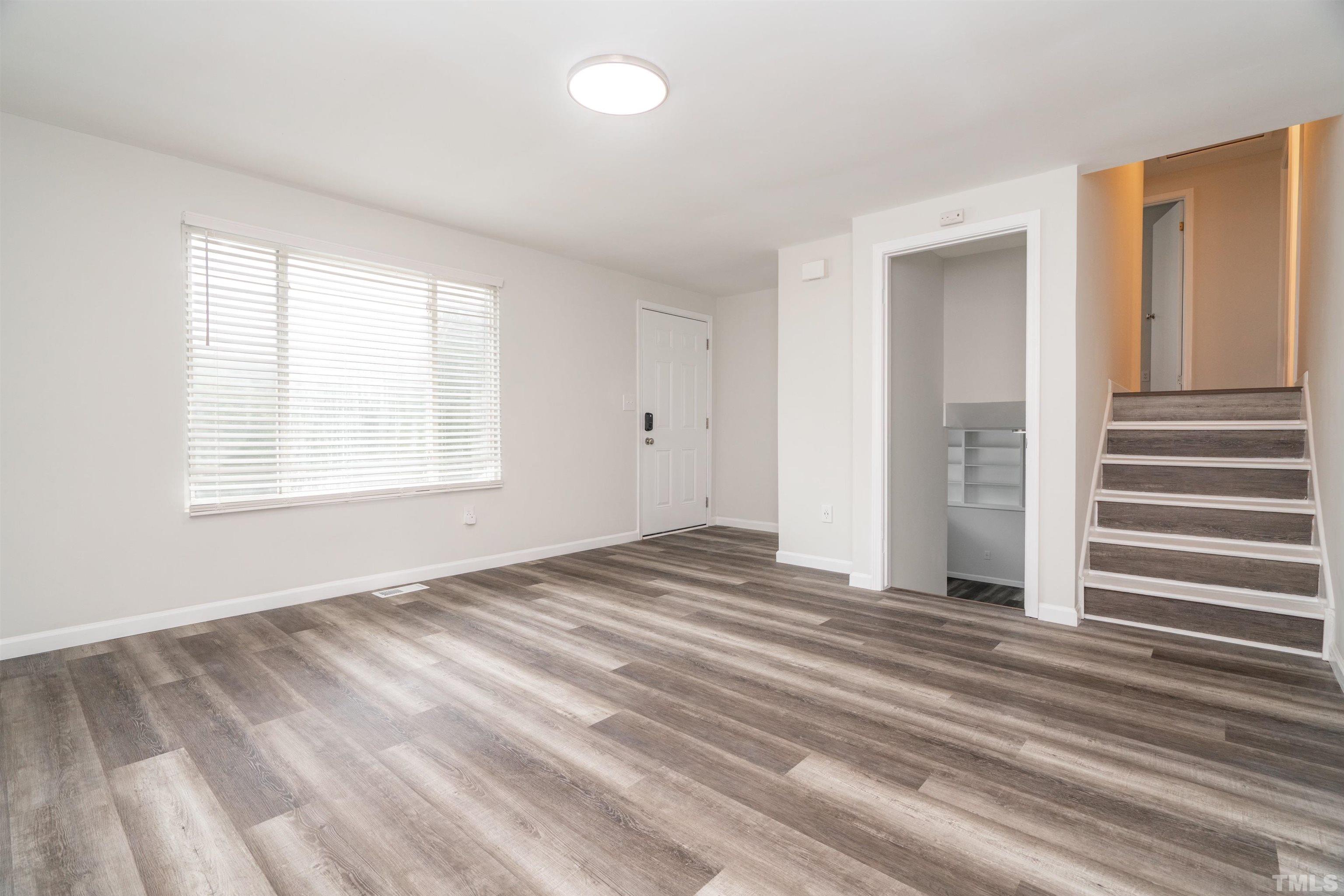 7901 Mourning Dove Road Raleigh, NC 27615 - Photo 3 of 21 a view of empty room with wooden floor and fan