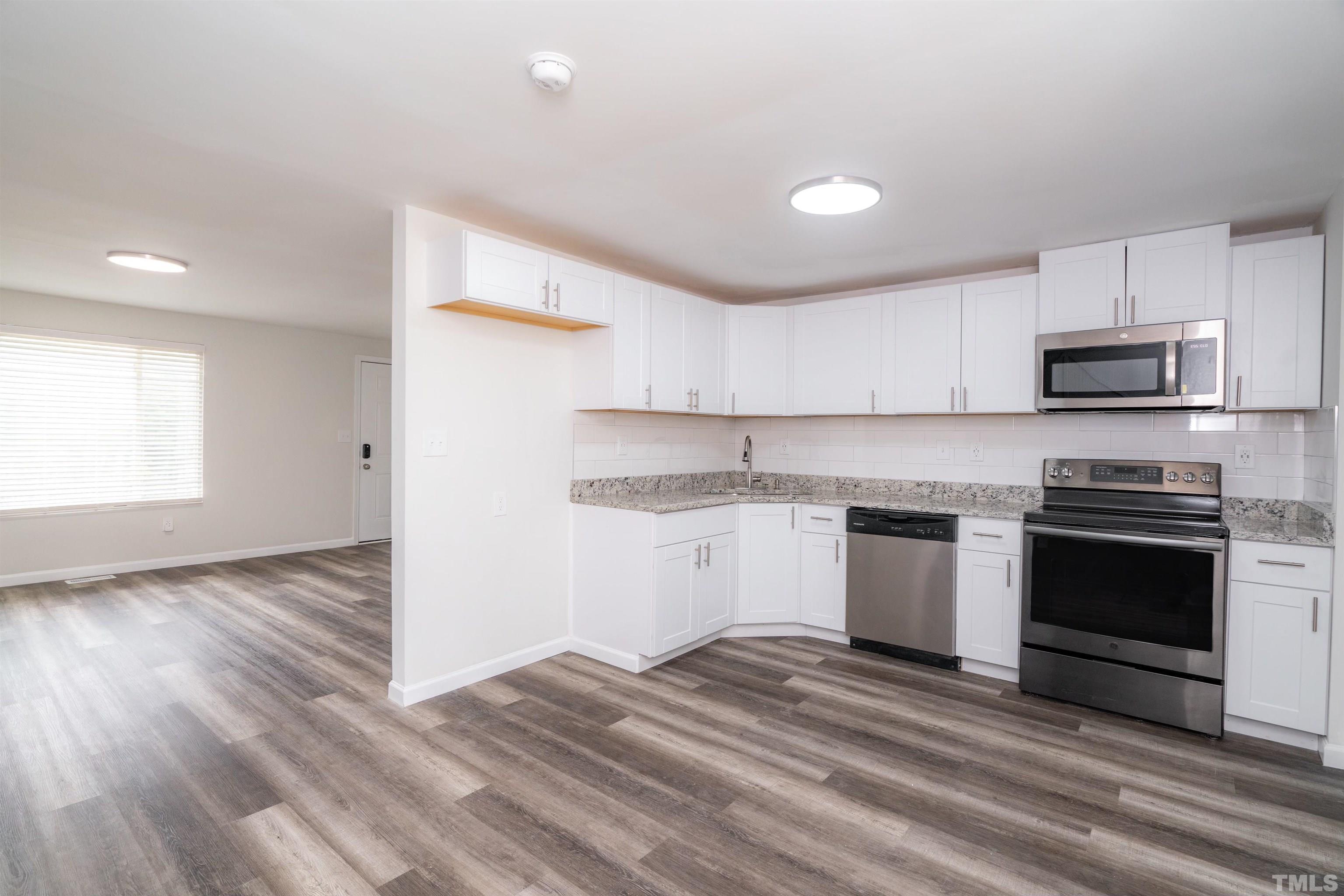 7901 Mourning Dove Road Raleigh, NC 27615 - Photo 8 of 21 a kitchen with a sink stove and microwave