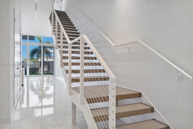 a view of staircase with white walls and windows