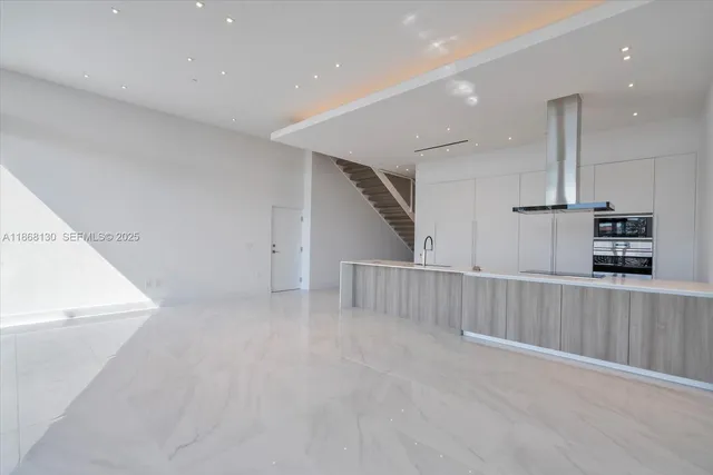 a view of staircase with white walls and windows