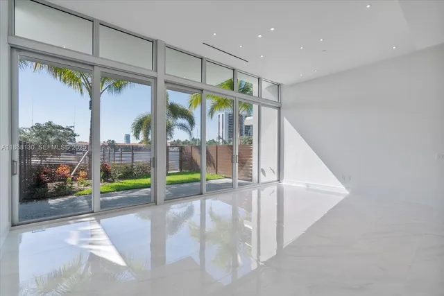 a bedroom with a large bed and a large window