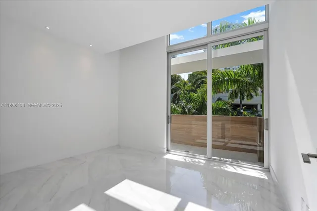 a view of an empty room with windows