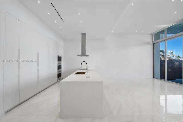 a bathroom with double vanity and mirrors