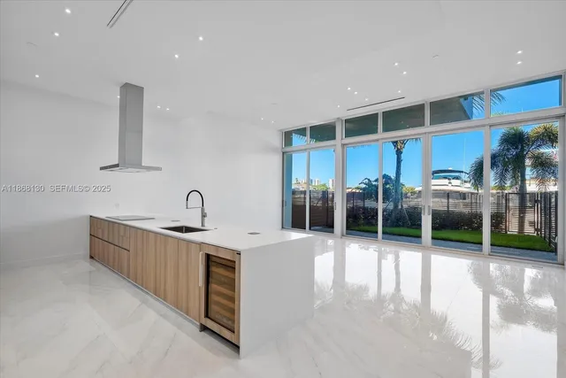 a kitchen with stainless steel appliances granite countertop a sink and a large window