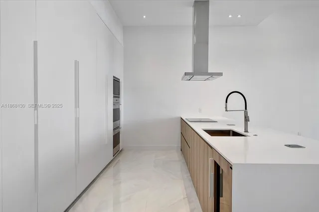 a kitchen with a sink and a refrigerator