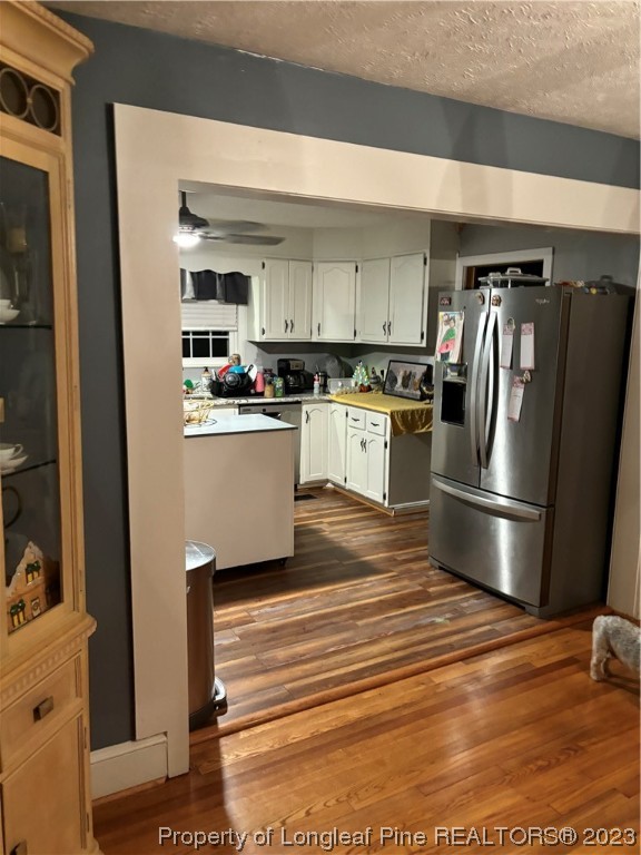 11828 Us Highway Maxton, NC 28364 - Photo 21 of 27 a kitchen with stainless steel appliances granite countertop a refrigerator a stove and a sink with wooden floor