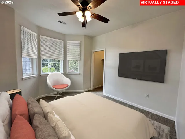 a bedroom with a large bed and a flat screen tv