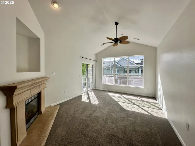 a big room with windows and a fireplace