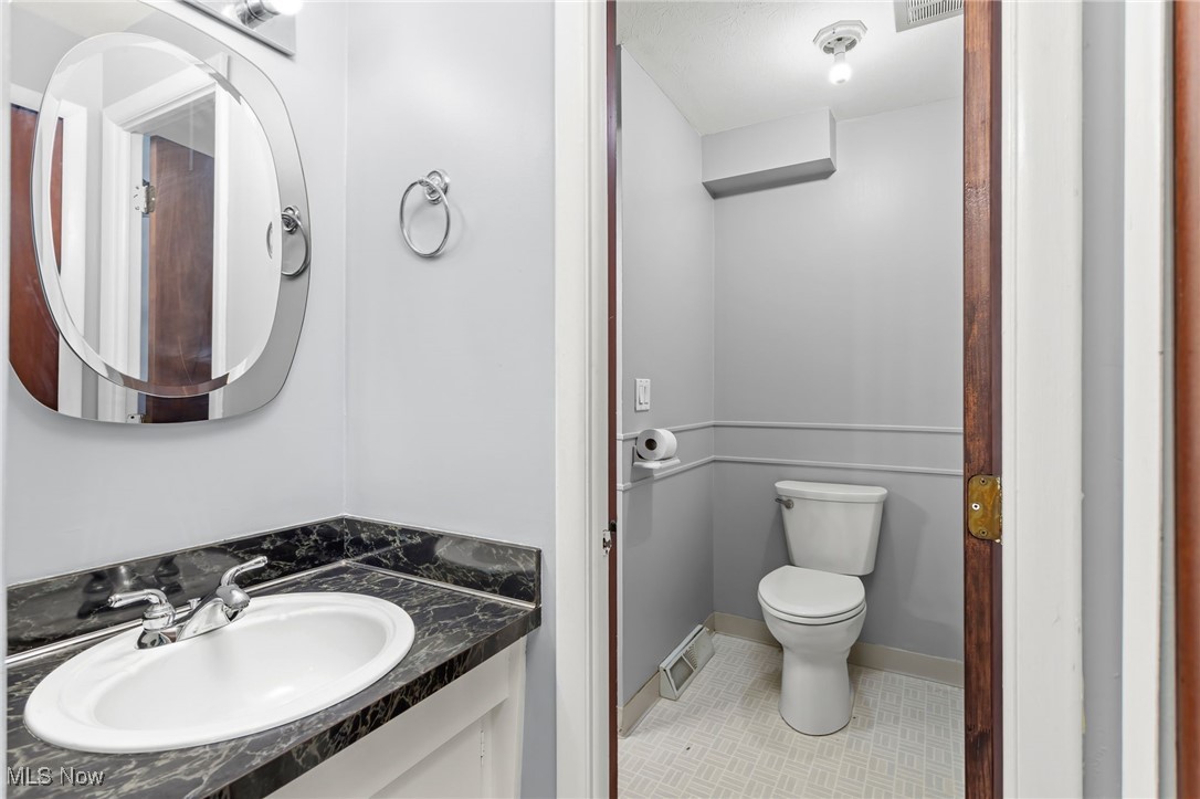 6480 State Road, Unit F7 Parma, OH 44134 - Photo 24 of 33 Half bath with tile patterned flooring and vanity