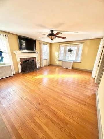 a living room with a fireplace and a floor to ceiling window