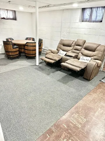 a living room with furniture a window and a fireplace