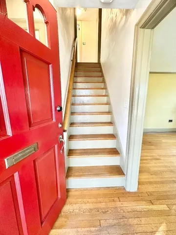 a view of front door with wooden floor