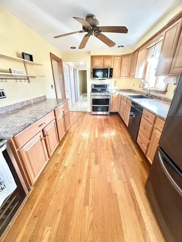 a kitchen with stainless steel appliances a refrigerator sink and cabinets