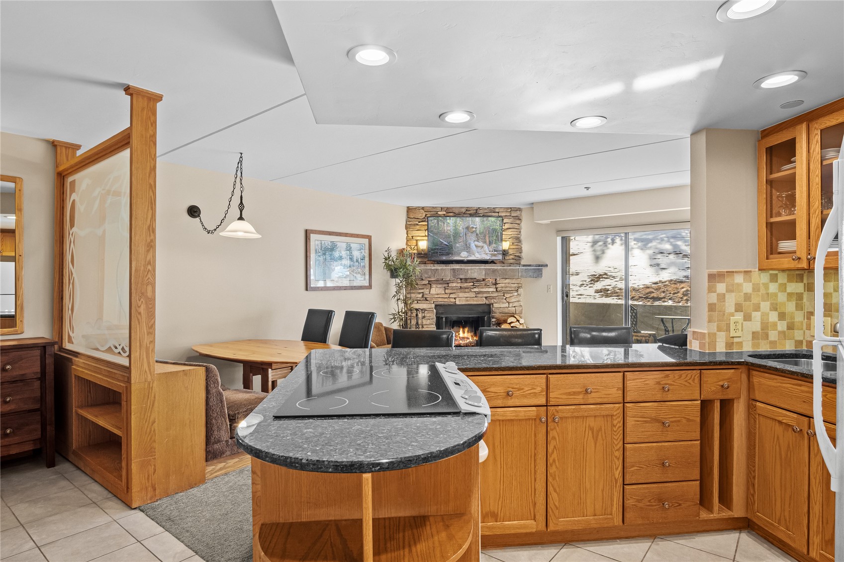640 Village Road, Unit 4110 Breckenridge, CO 80424 - Photo 12 of 50 a living room with furniture a dining table and a fireplace