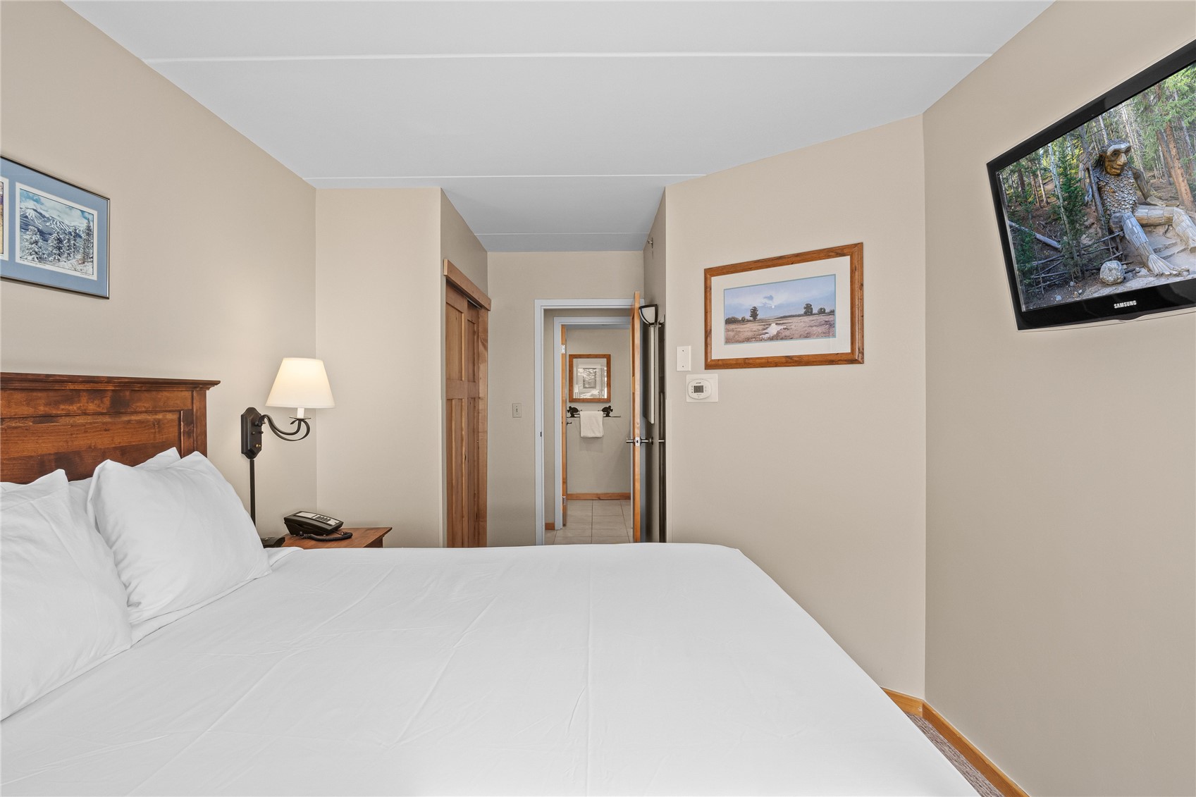 640 Village Road, Unit 4110 Breckenridge, CO 80424 - Photo 22 of 50 a bedroom with a bed and a painting on the wall