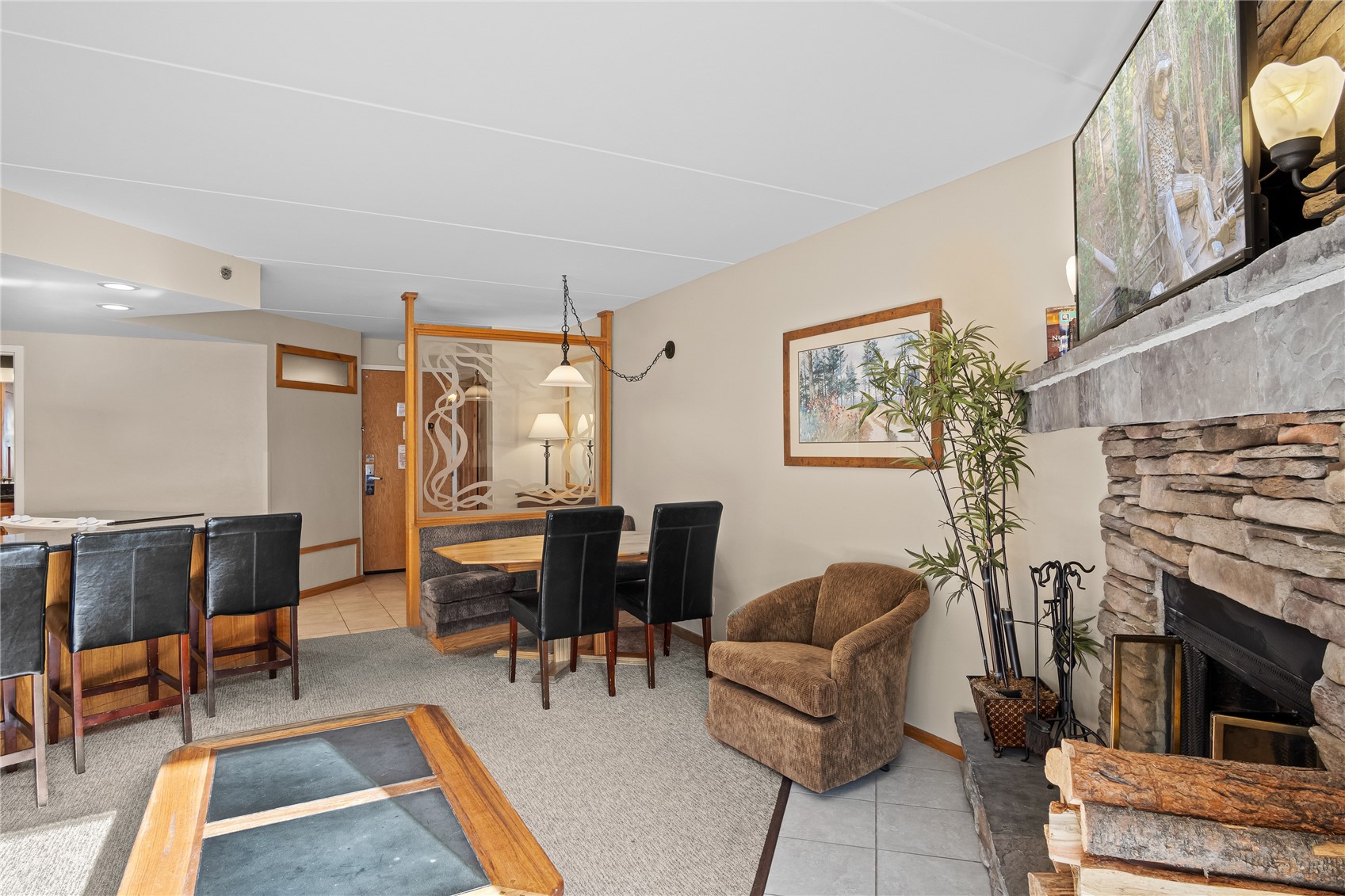 640 Village Road, Unit 4110 Breckenridge, CO 80424 - Photo 6 of 50 a living room with furniture a fireplace and a flat screen tv