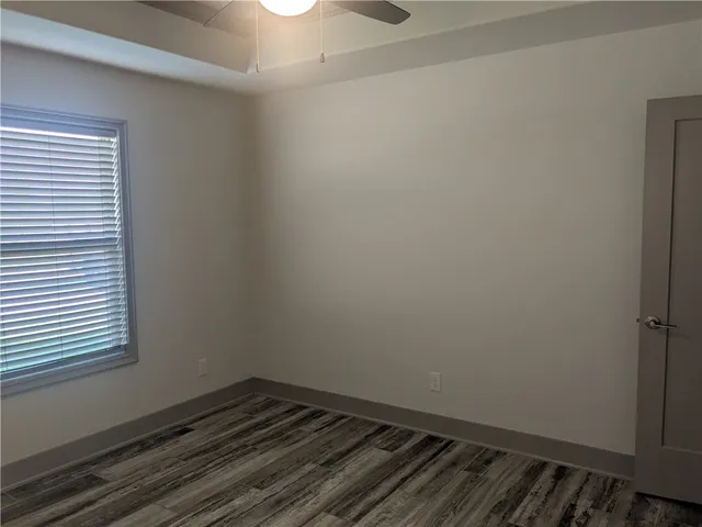 a view of a room with wooden floor