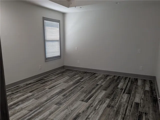 a view of a room with wooden floor and window