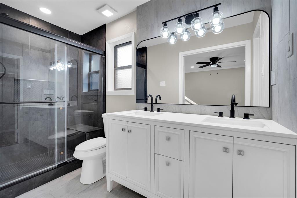 221 North Edgefield Road Waxahachie, TX 75165 - Photo 13 of 27 a bathroom with a double vanity sink toilet and shower