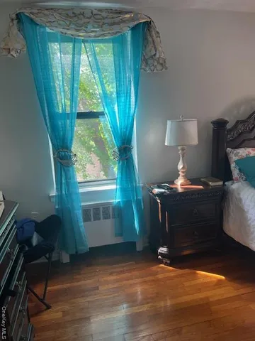 a view of room with window and hardwood floor