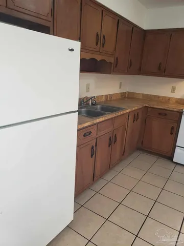 a kitchen with a refrigerator and a sink