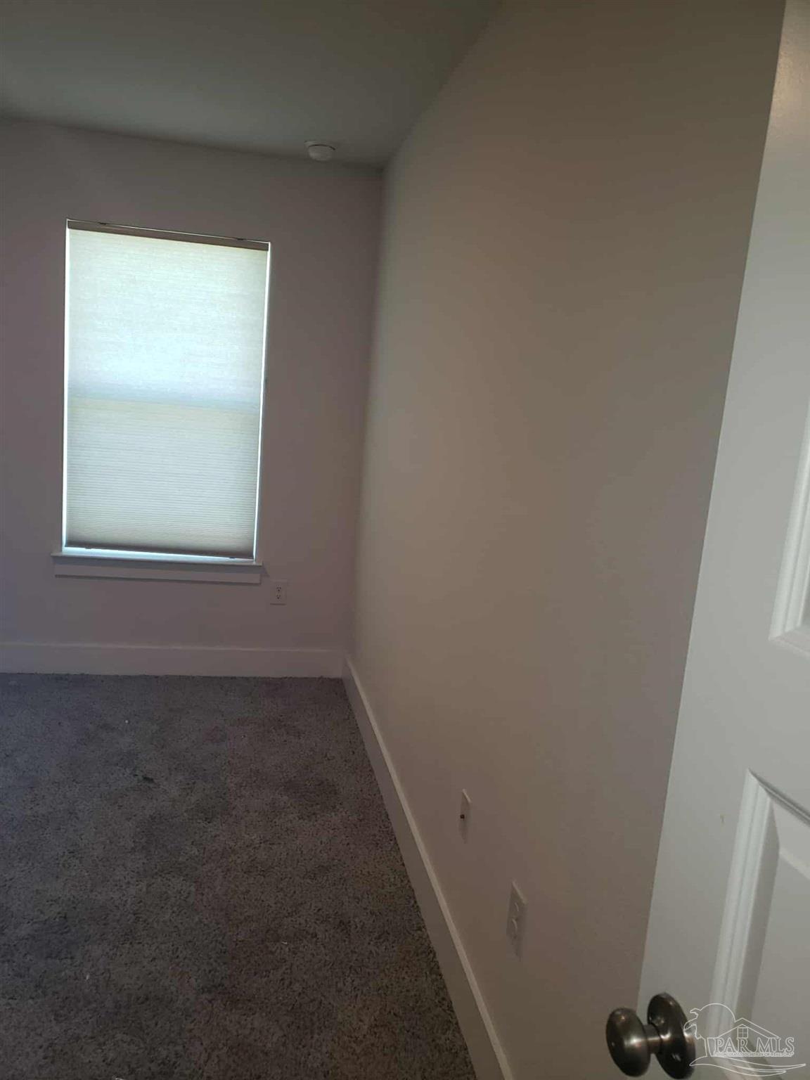 820 Calhoun Avenue, Unit A Pensacola, FL 32507 - Photo 4 of 9 an empty room with a window