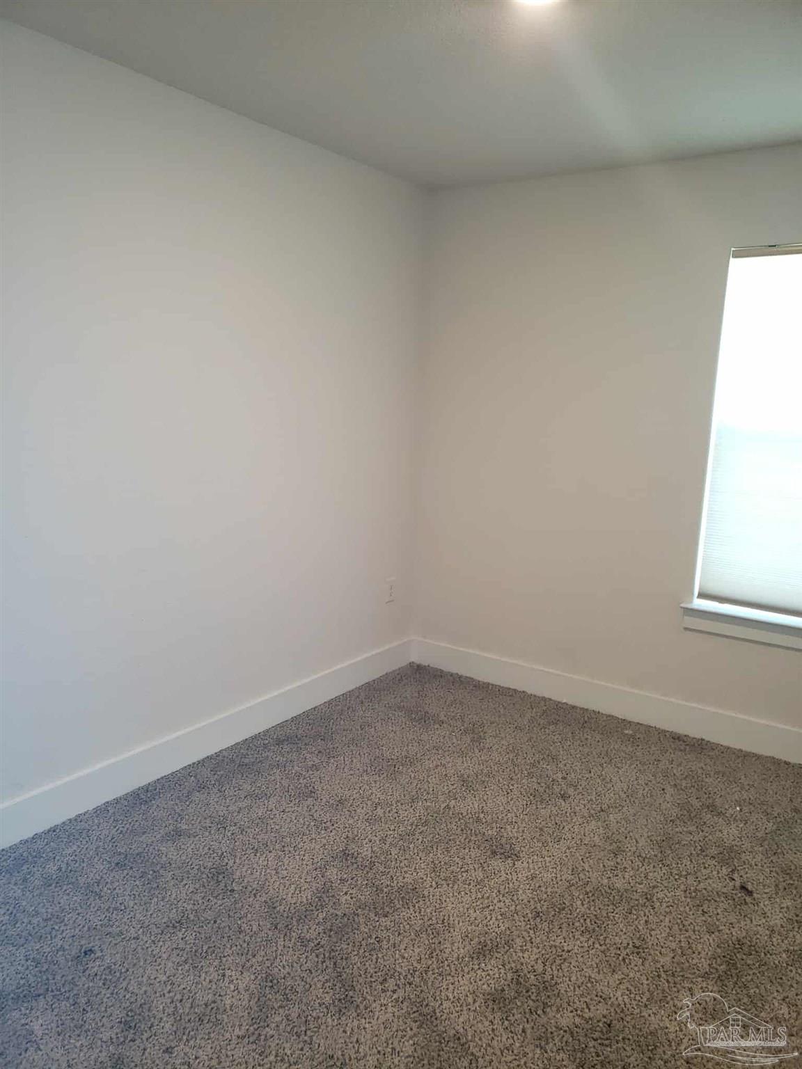 820 Calhoun Avenue, Unit A Pensacola, FL 32507 - Photo 7 of 9 an empty room with a window