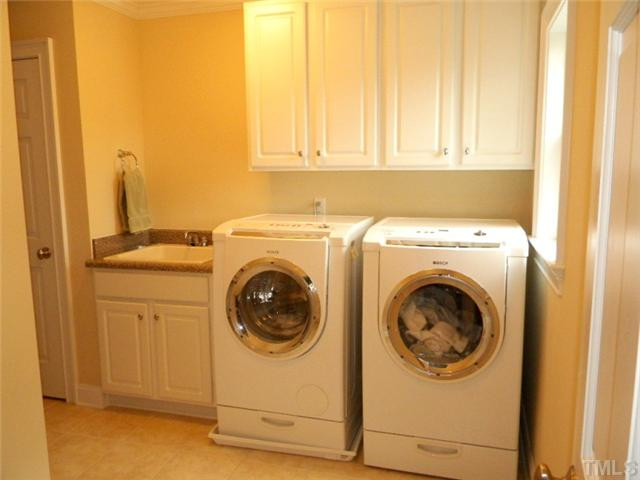 3704 Laurel Hills Road Raleigh, NC 27612 - Photo 18 of 25 Plenty of room in the second floor laundry room with sink. There is even room to set up an ironing board! Laundry Room